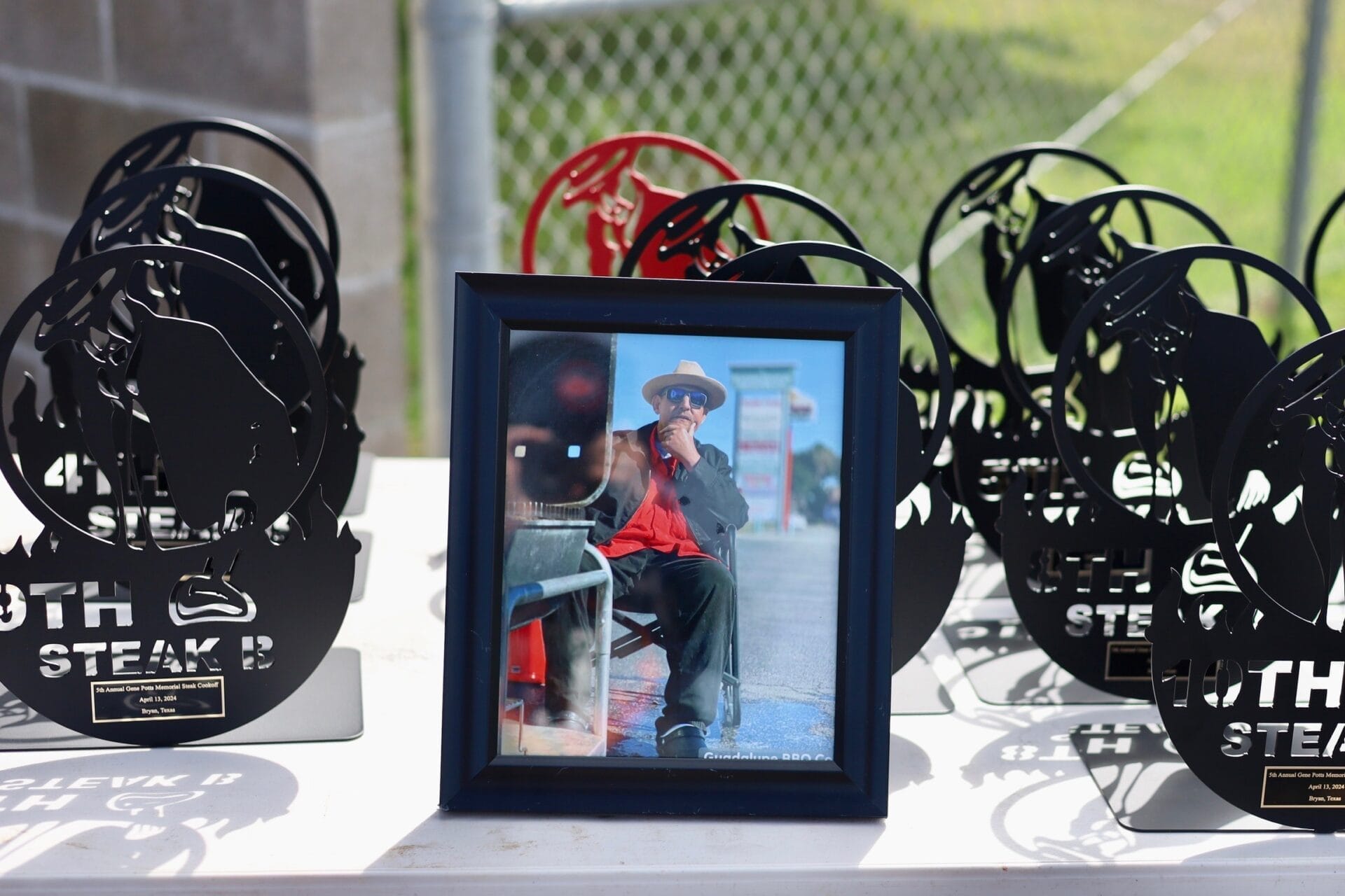 Gene Potts surround by the awards